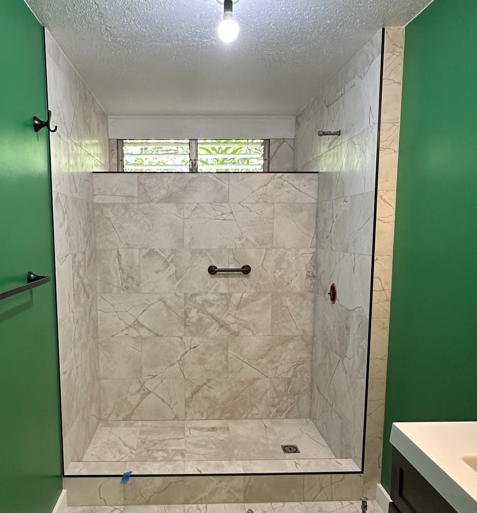 Remodeled bathroom with customer selected green paint and tiled shower