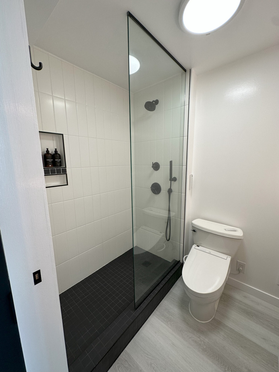 Tiled shower and new flooring in bathroom