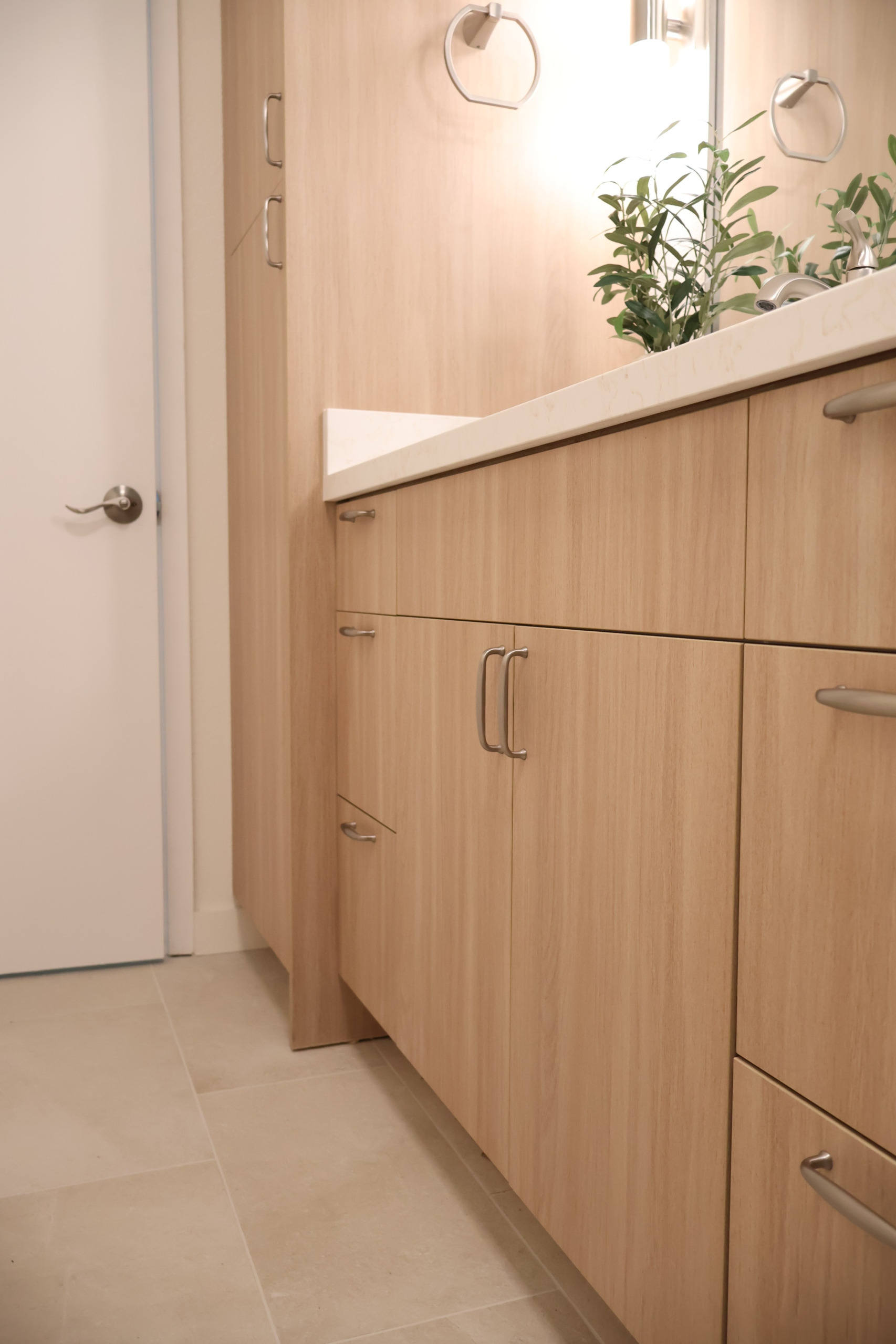Kailua bathroom remodel featuring a light wood vanity, natural quartz, and understated brushed nickel fixtures.