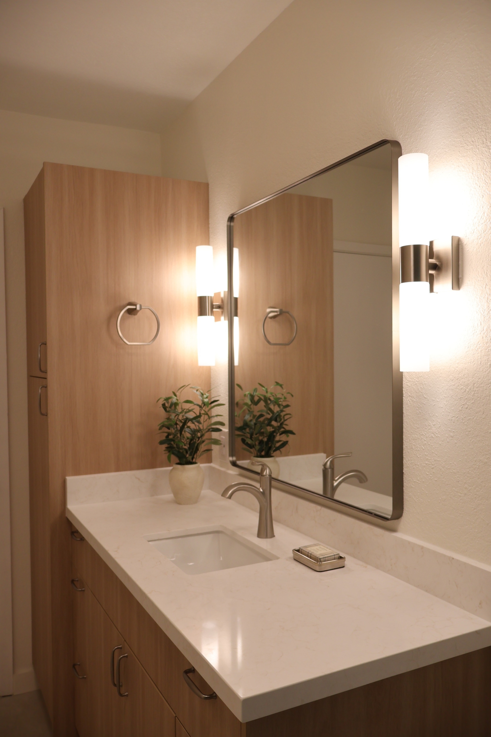 Built-in shower niche with neutral tile details that complement the bathroom’s soft sea-and-sand inspired design.